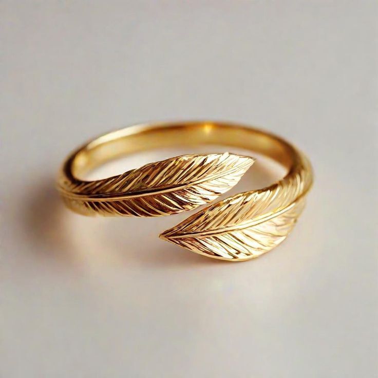 a gold vermeil ring with a delicate palm leaf wrap around design